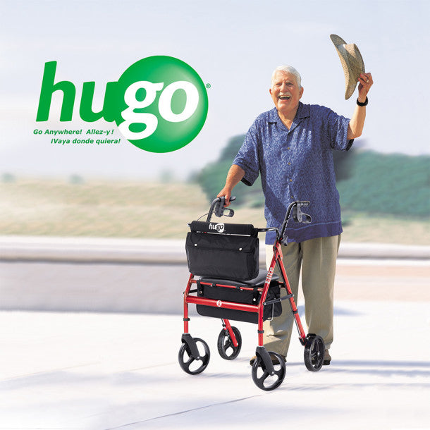 Man pushing a red and black Hugo rollator with a scenic background