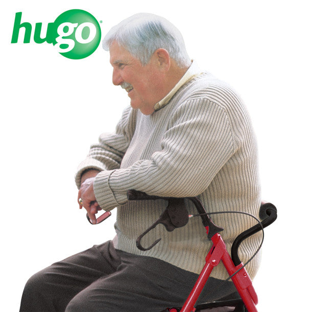 Man sitting on a red exercise bike with 'hugo' logo above