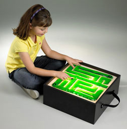 Child playing with a maze toy on a gray background