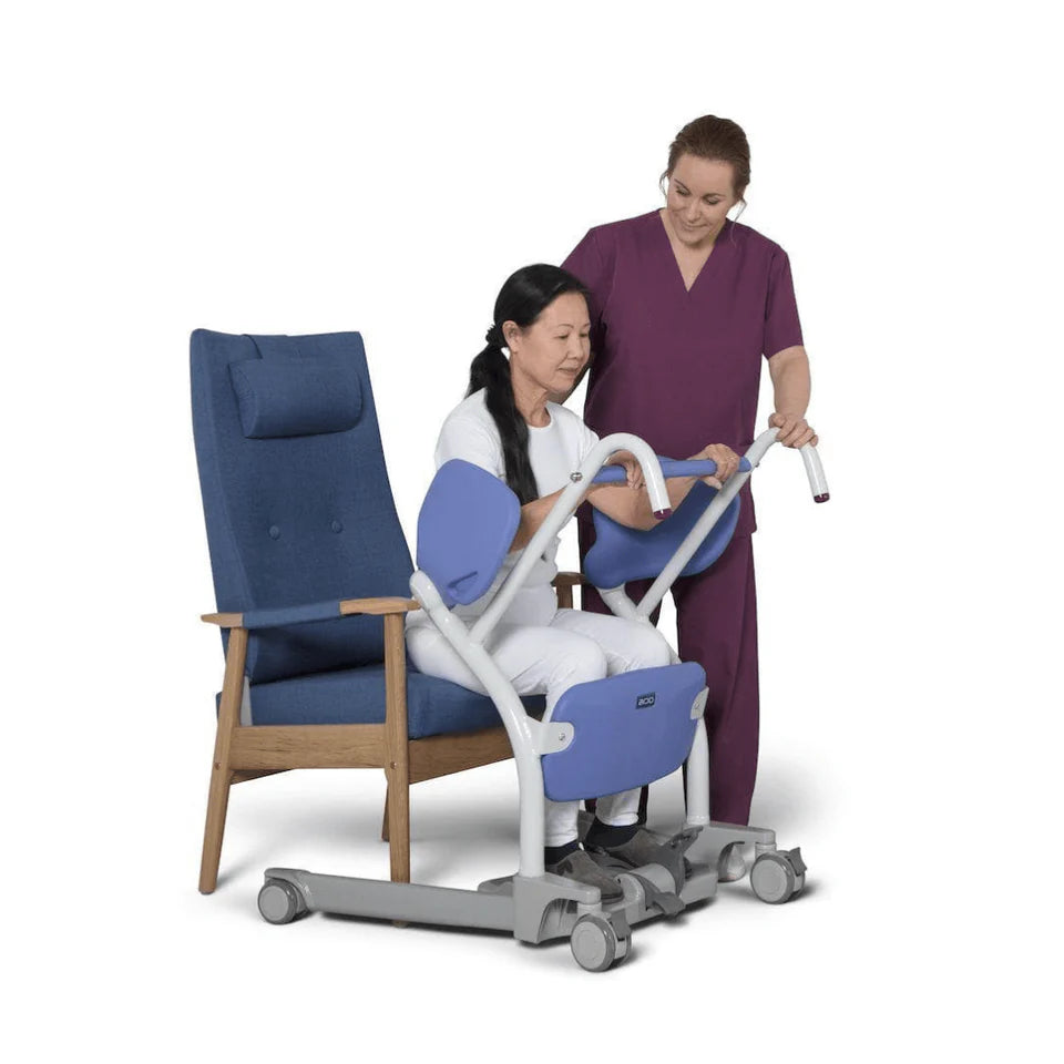Person using a medical chair with assistance from another person on a white background