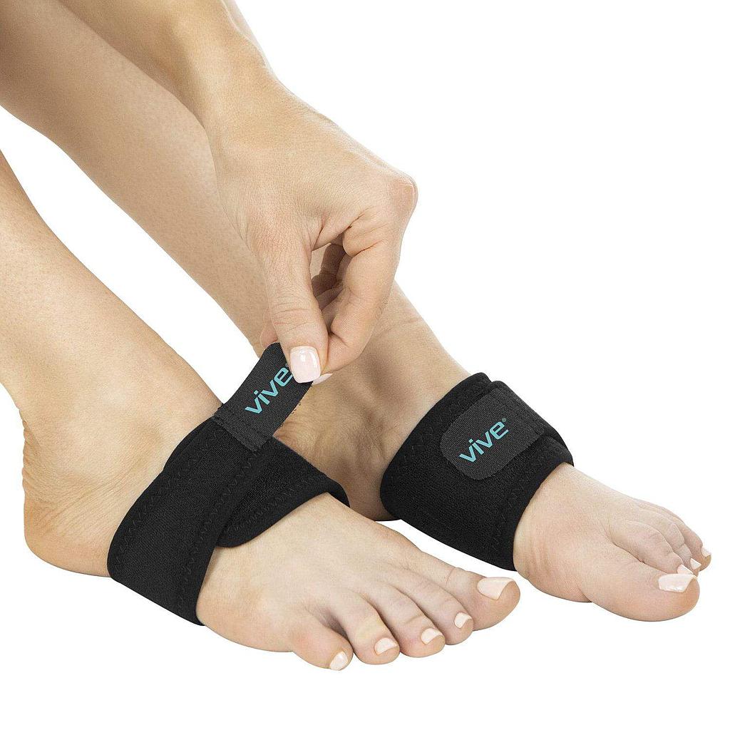 Person wearing black ankle support straps with 'Vive' branding on a white background
