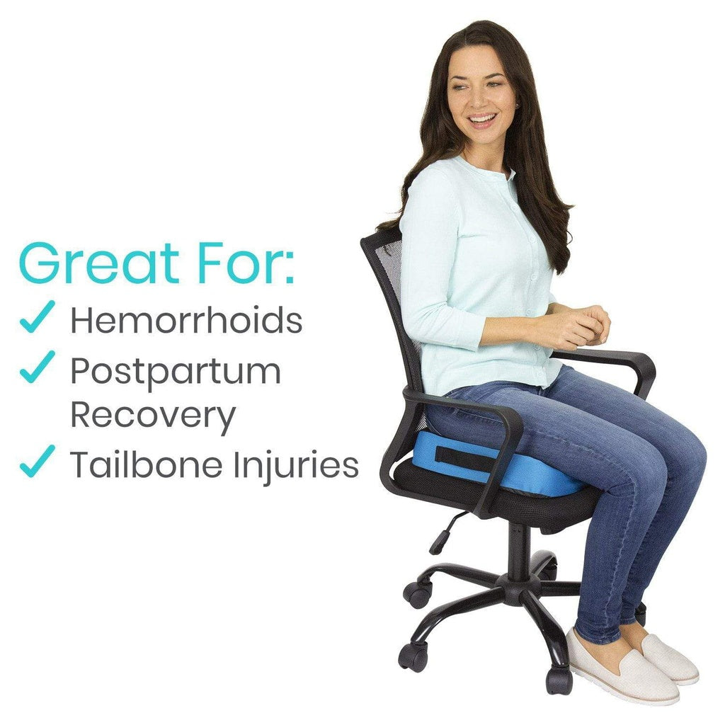 Woman sitting on a chair with a blue cushion, promoting its use for hemorrhoids, postpartum recovery, and tailbone injuries.