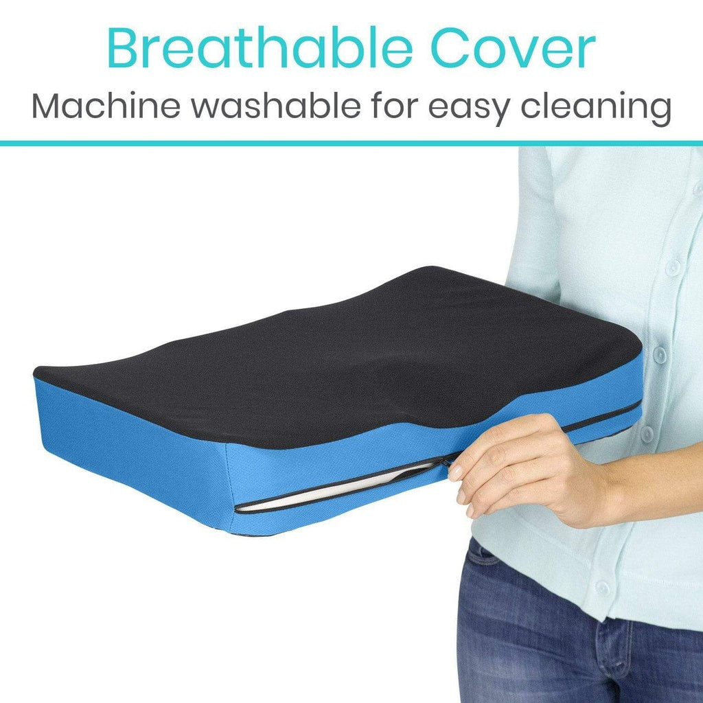 Blue and black cushion with breathable cover feature, held by a person.