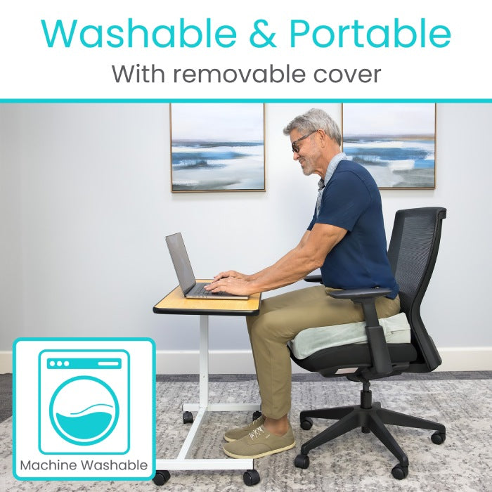 Man using a laptop on a portable desk with washable and portable features highlighted.