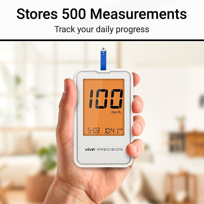 Hand holding a glucose meter with digital display, brand 'Vive Precision' visible, against a blurred indoor background.