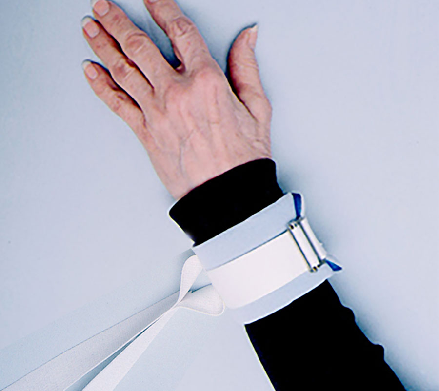 Hand wearing a white brace on a light blue background