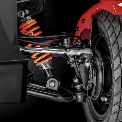 Close-up of a motorcycle suspension system with orange springs on a black background