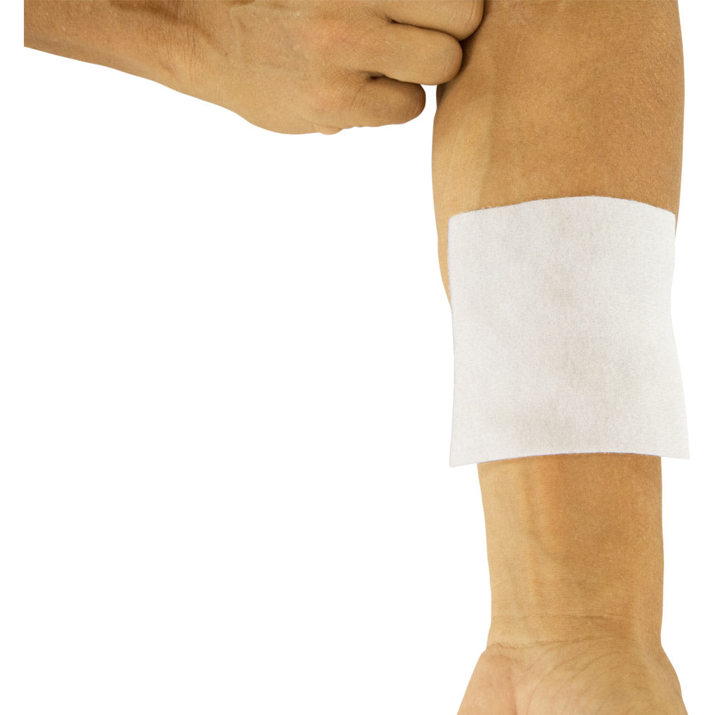 White bandage on a person's arm against a white background