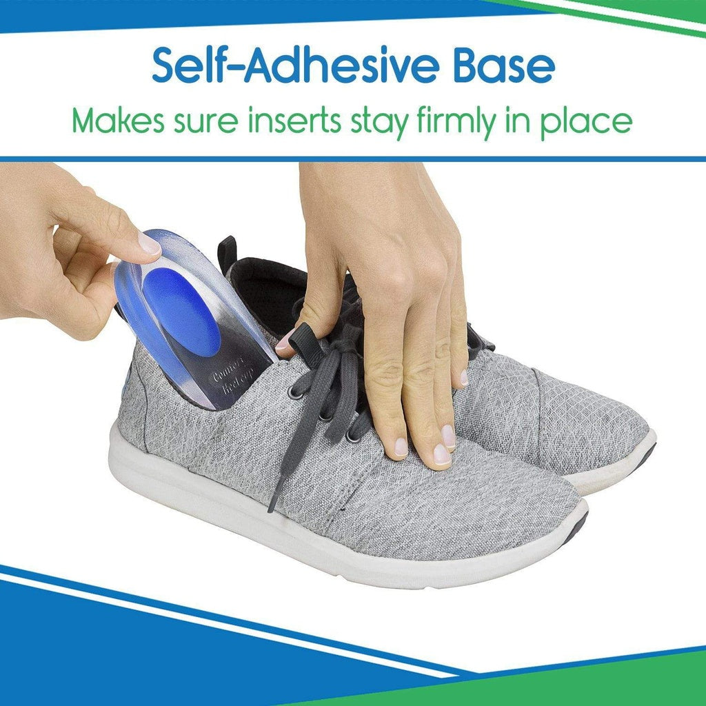 Person inserting a shoe insert with a self-adhesive base into a gray sneaker.