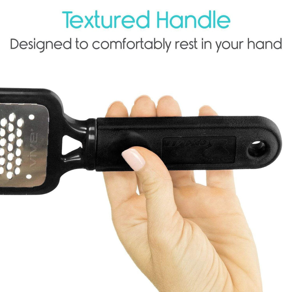 Black grooming brush with textured handle held by a hand, text 'Textured Handle Designed to comfortably rest in your hand' above.