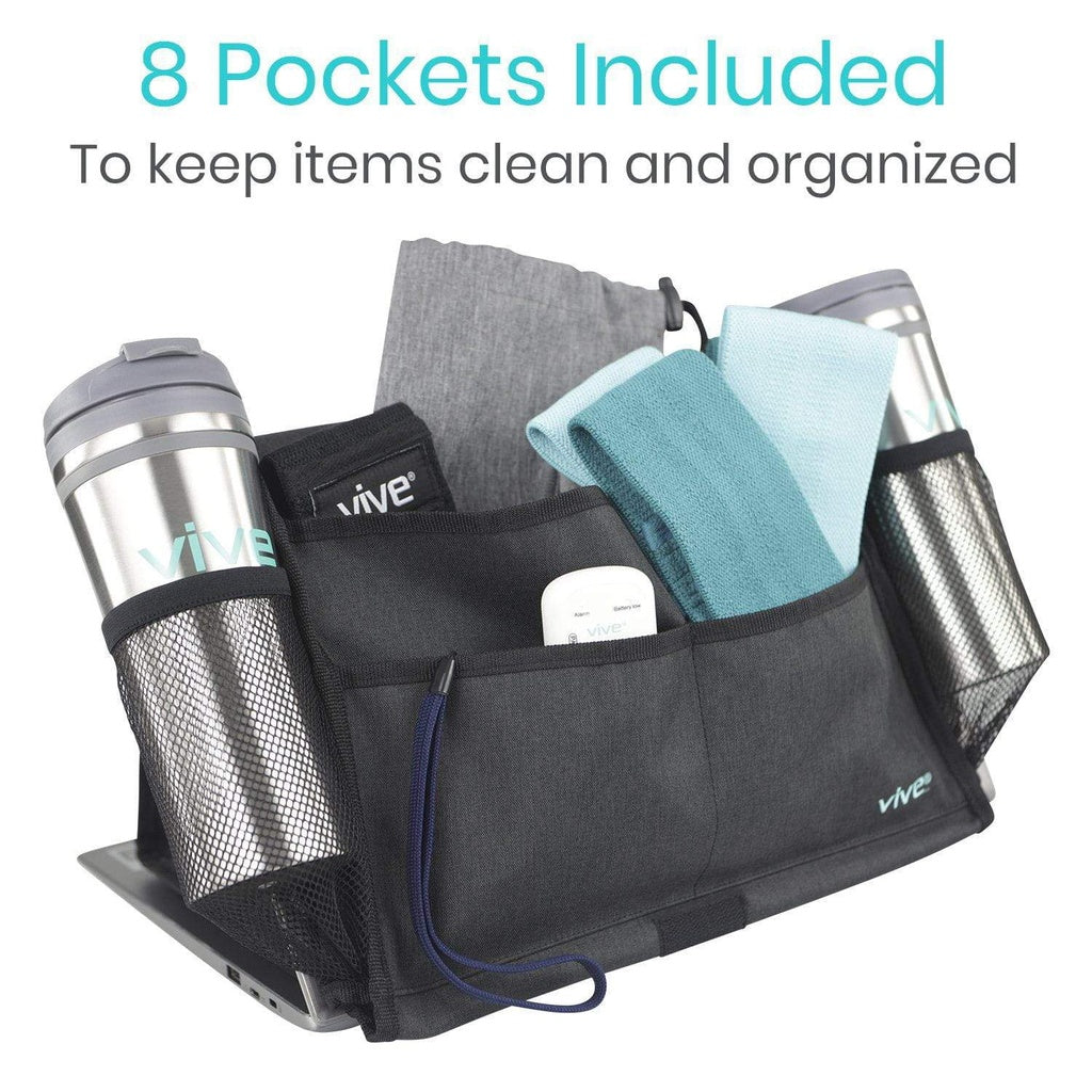 Black organizer with multiple pockets containing a tumbler, towel, and other items on a white background.