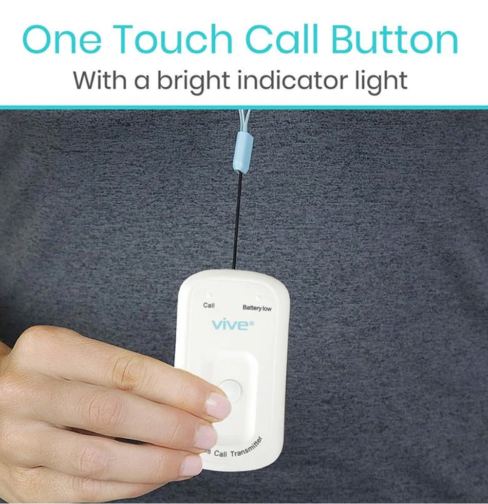 One touch call button with a bright indicator light held by a hand against a dark background