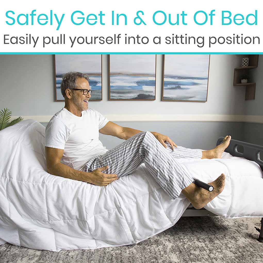 Man sitting on a bed using a device to safely get in and out of bed