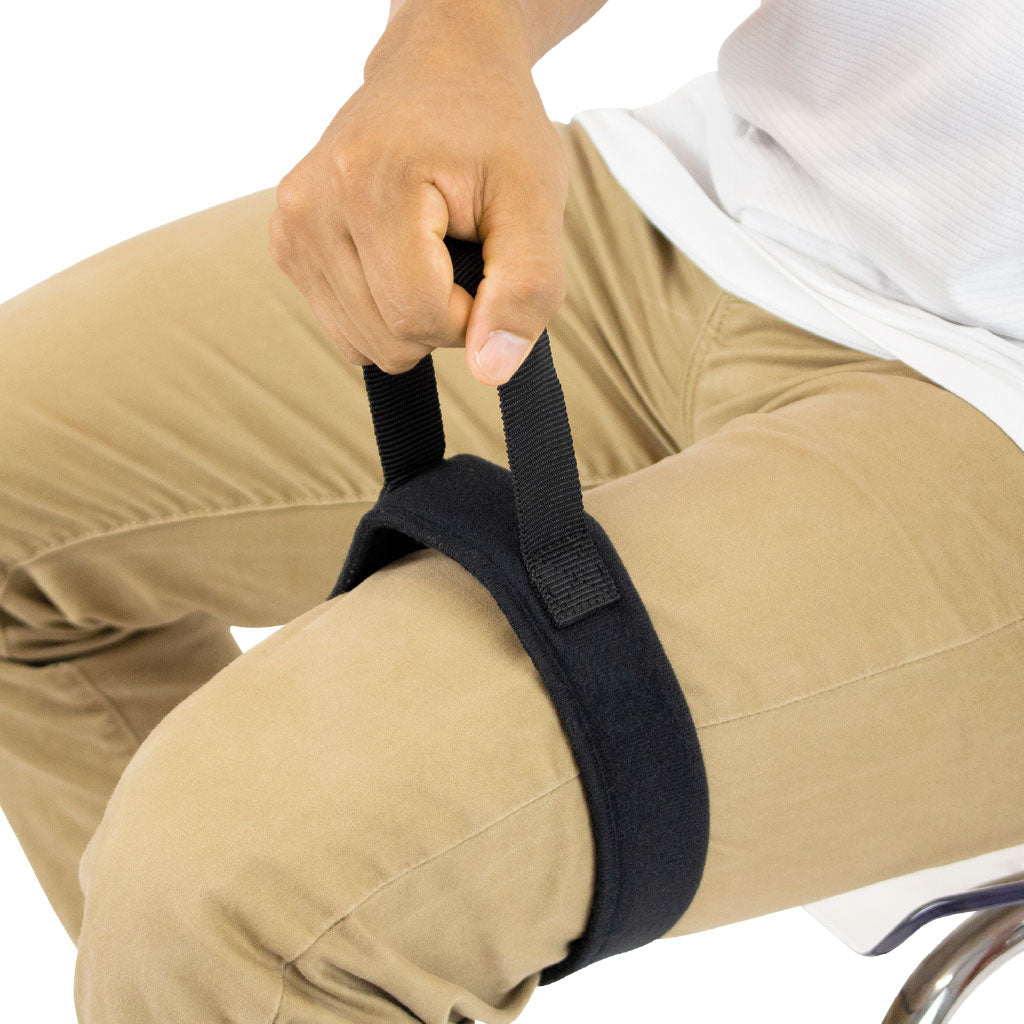 Person using a black knee brace on a white background