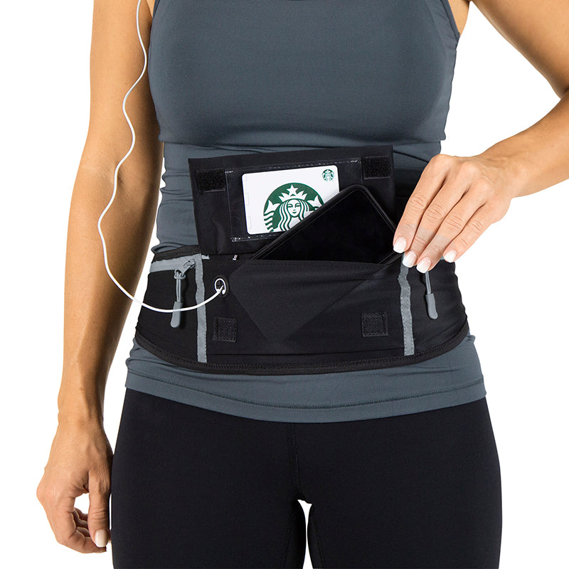 Person wearing a black waist pouch with a Starbucks card on a white background
