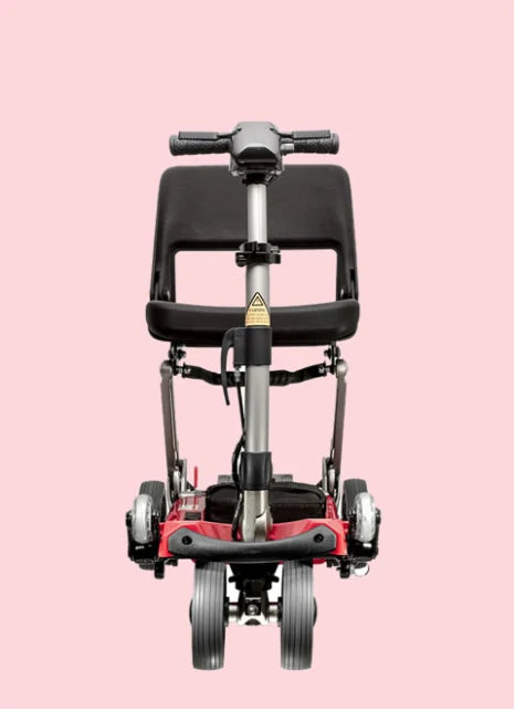 Red and black scooter on a pink background