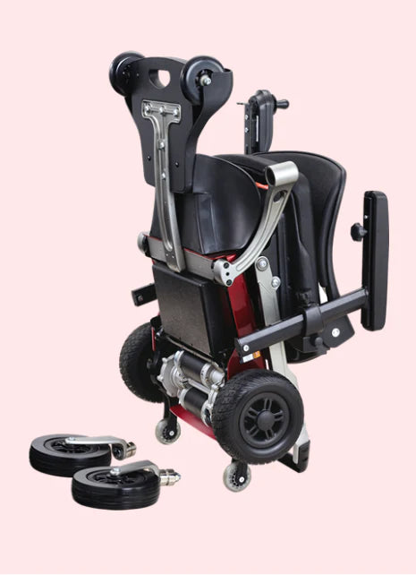 Black and red wheelchair with wheels on a pink background