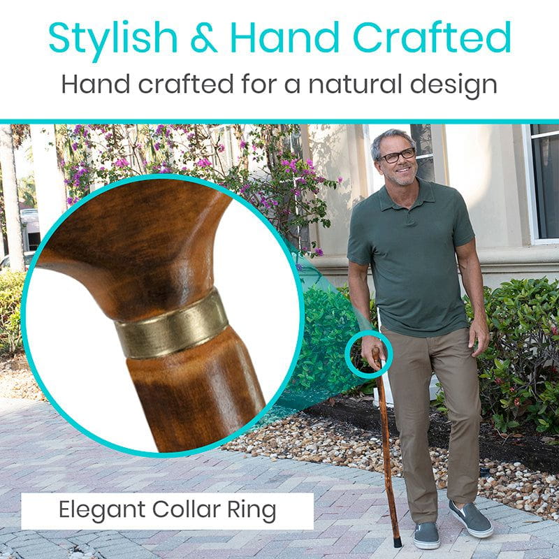 Man holding a walking stick with an elegant collar ring, surrounded by nature.