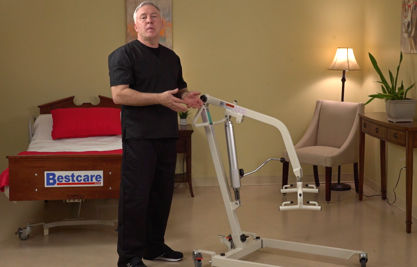 PL400HE patient lift left side view with Caregiver