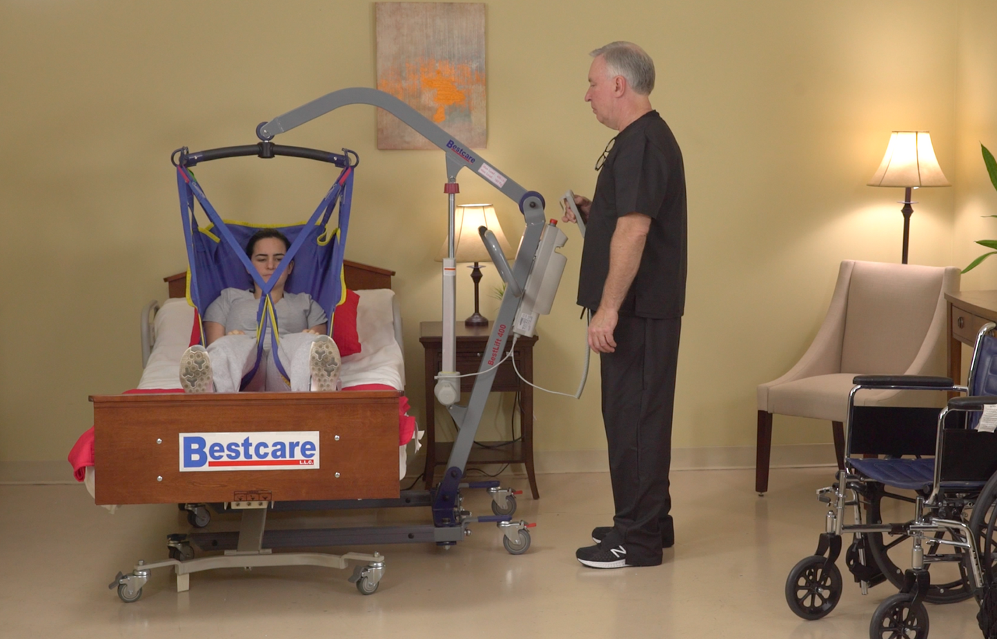 PL500 patient lift placing patient in bed