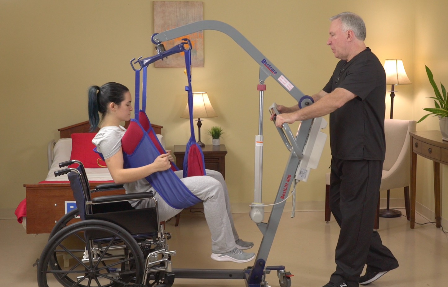 PL500 patient lift being used to lift patient out of wheelchair