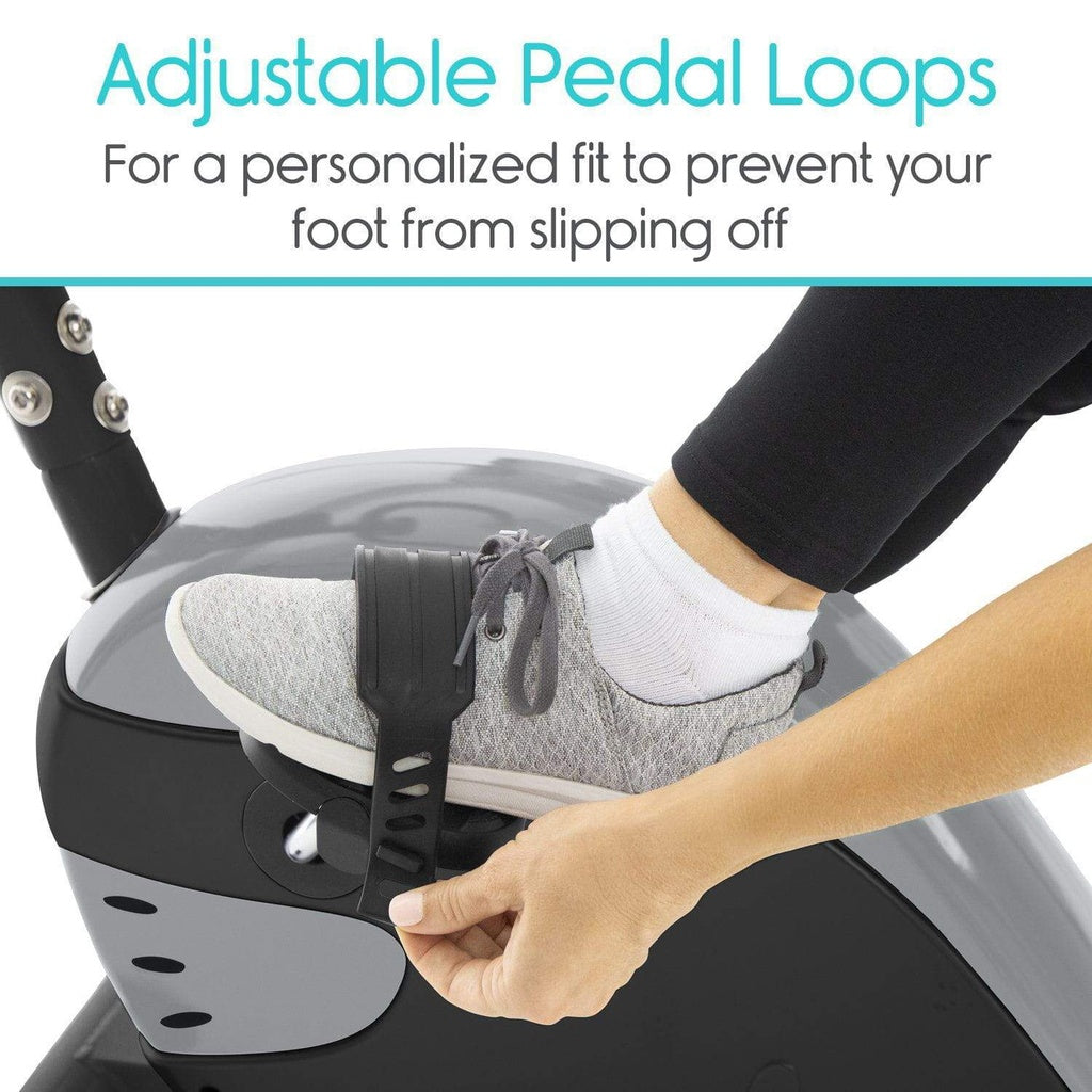 Person using adjustable pedal loops on a piece of exercise equipment.