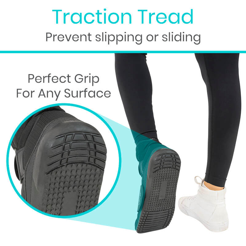 Teal shoe with black traction tread on a white background