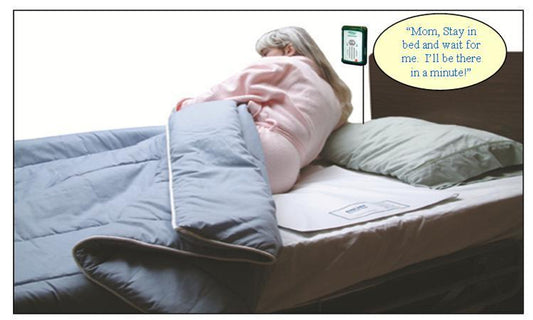 Person lying in bed with a smartphone displaying a message, surrounded by a blue blanket and green pillow.