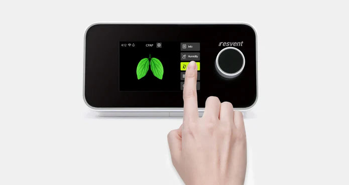 Hand interacting with a smart device displaying 'resvent' on a white background