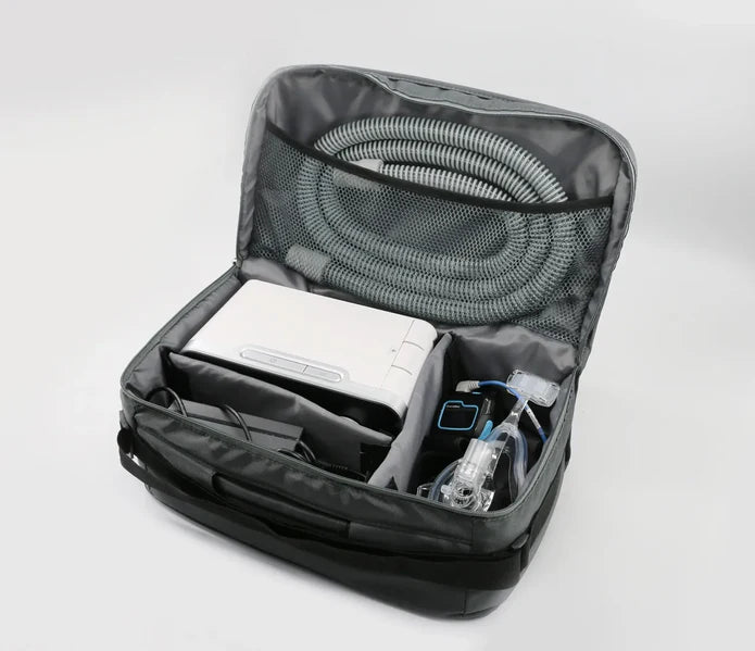 Black backpack with medical equipment inside on a white background