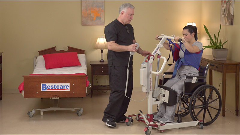 SA400HE being used by a caregiver to lift a patient out of a wheelchair