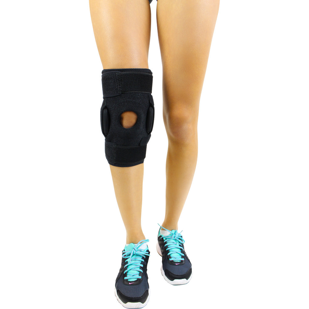 Black knee brace on a mannequin leg with a white background