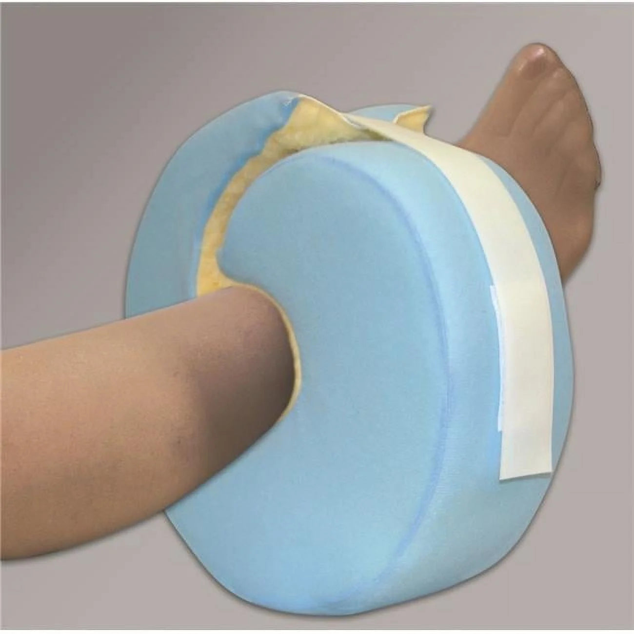 Blue leg elevation pillow with a white band on a gray background