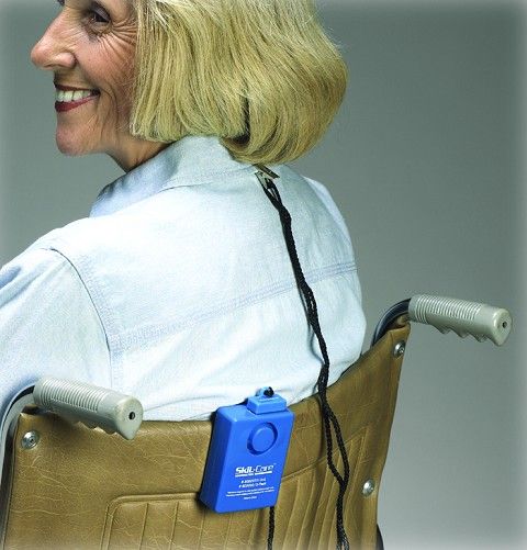 woman sitting in wheelchair with alarm attached