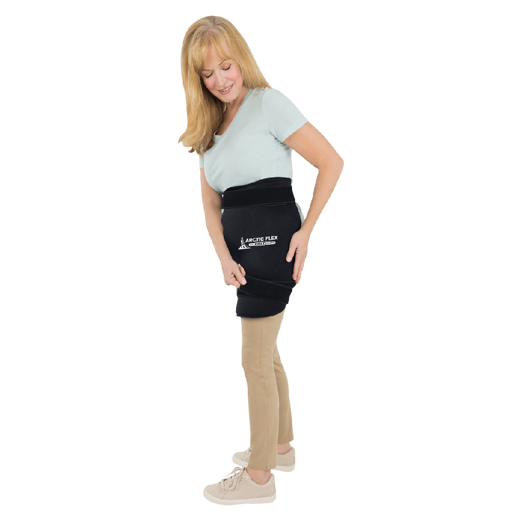 Woman wearing a black heating pad on her abdomen with a visible brand logo.