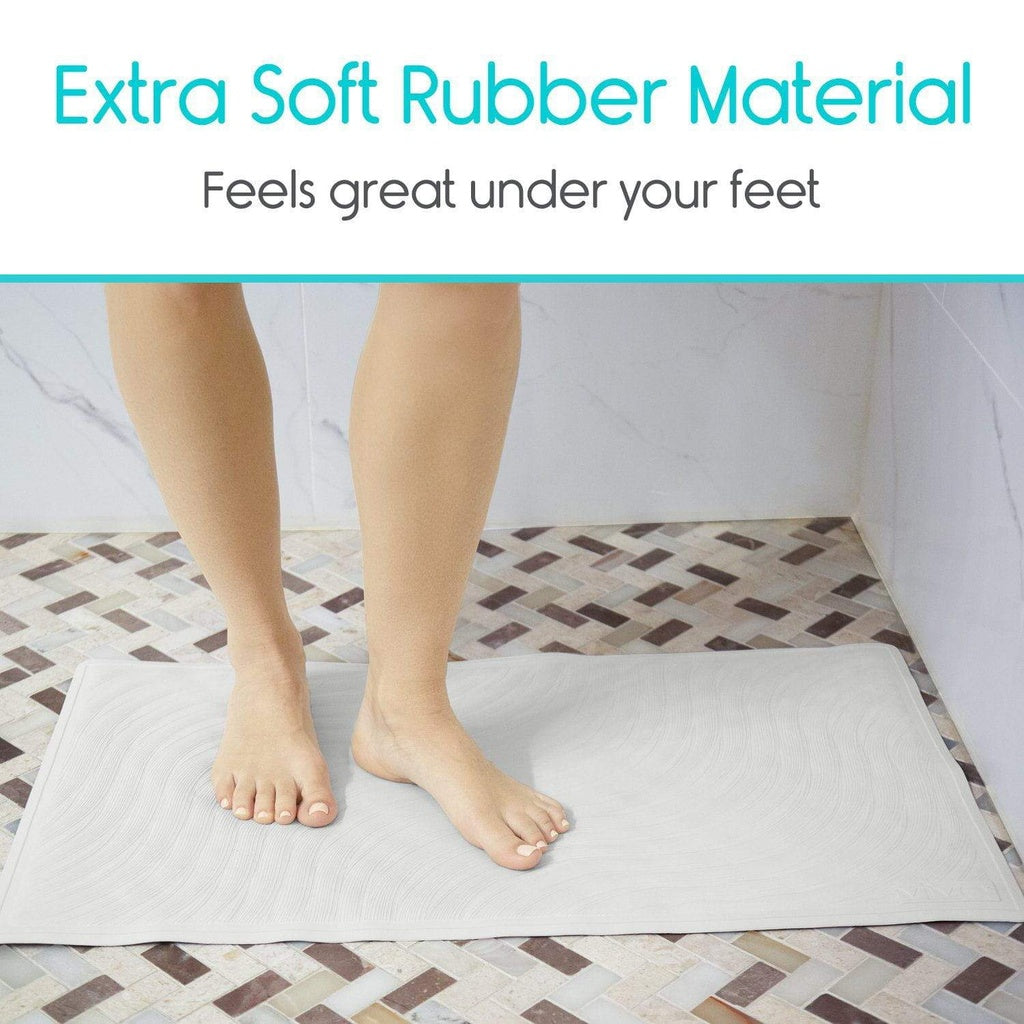 Person standing on a bath mat with text about extra soft rubber material