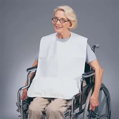 woman wearing a bib sitting in a wheelchair
