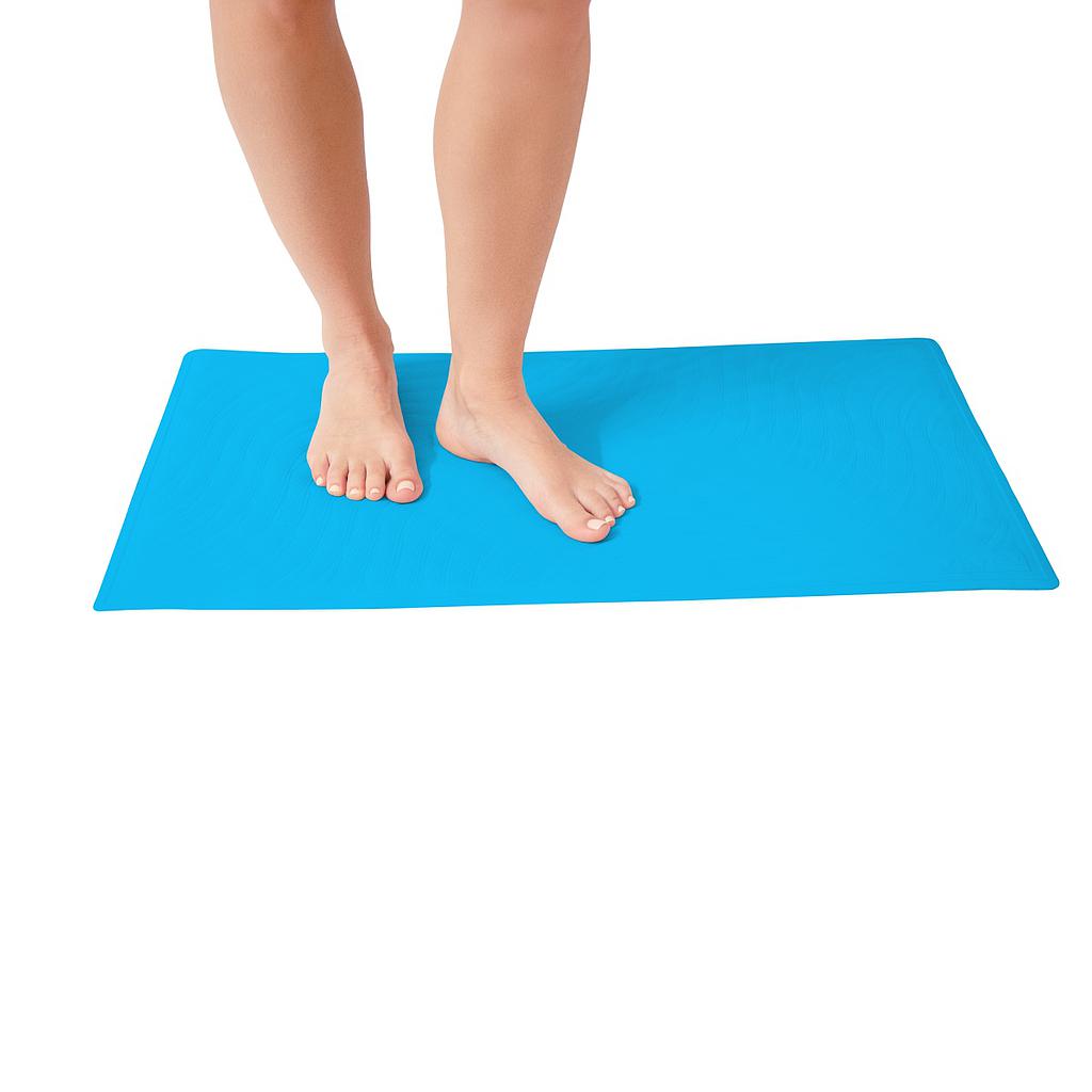 Person standing on a blue bath mat with a white background