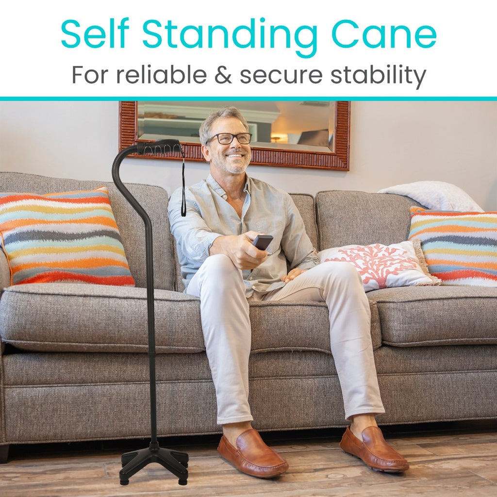 man sitting next to his quad cane