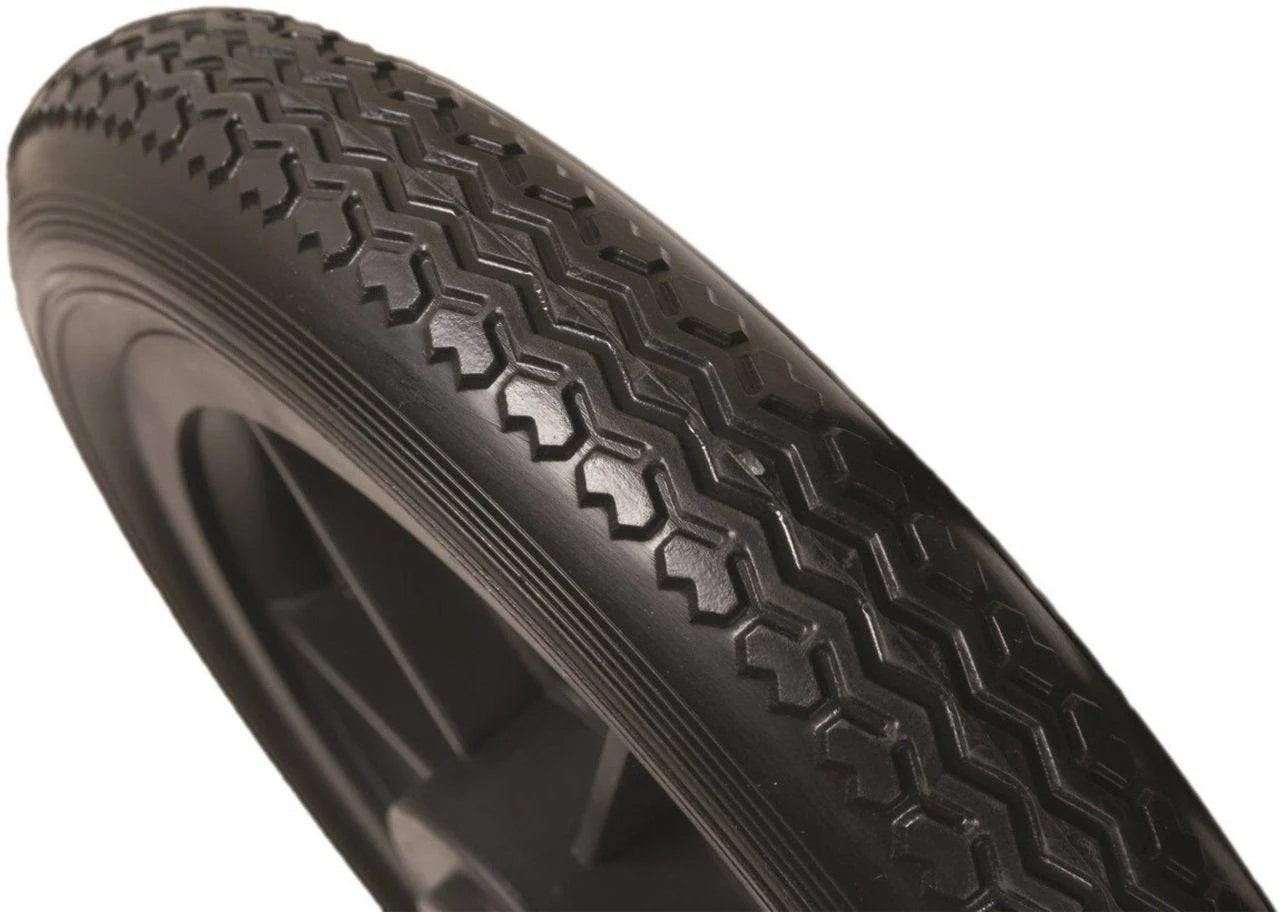 Close-up of a black tire with tread pattern on a white background