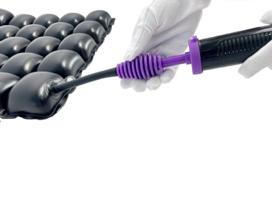Hand holding a purple pump nozzle over an inflatable product on a white background