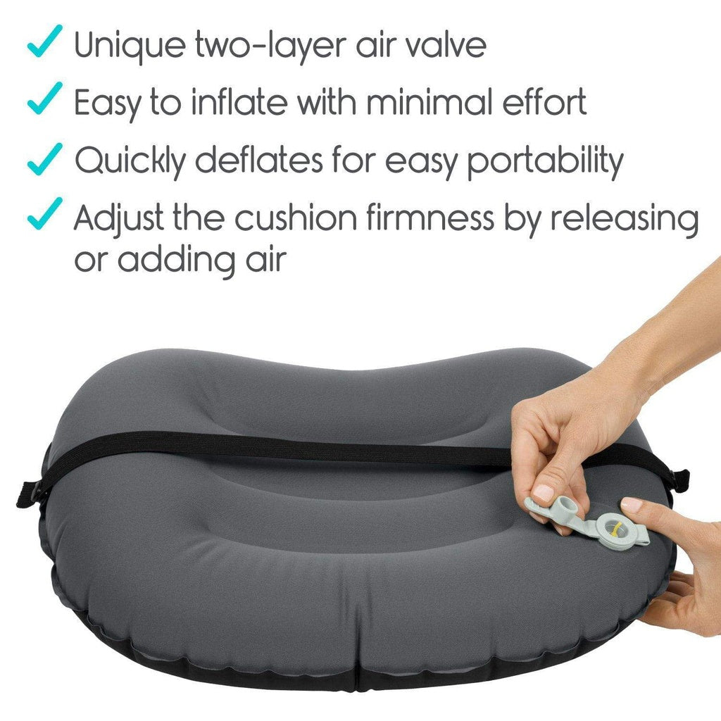 Inflatable travel pillow with hand adjusting valve on a white background