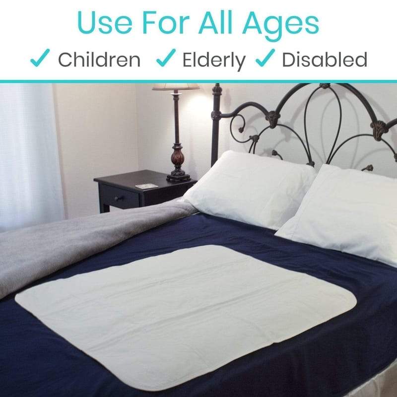 Bed with a mattress pad on a bed in a bedroom setting, labeled for use by all ages including children, elderly, and disabled.