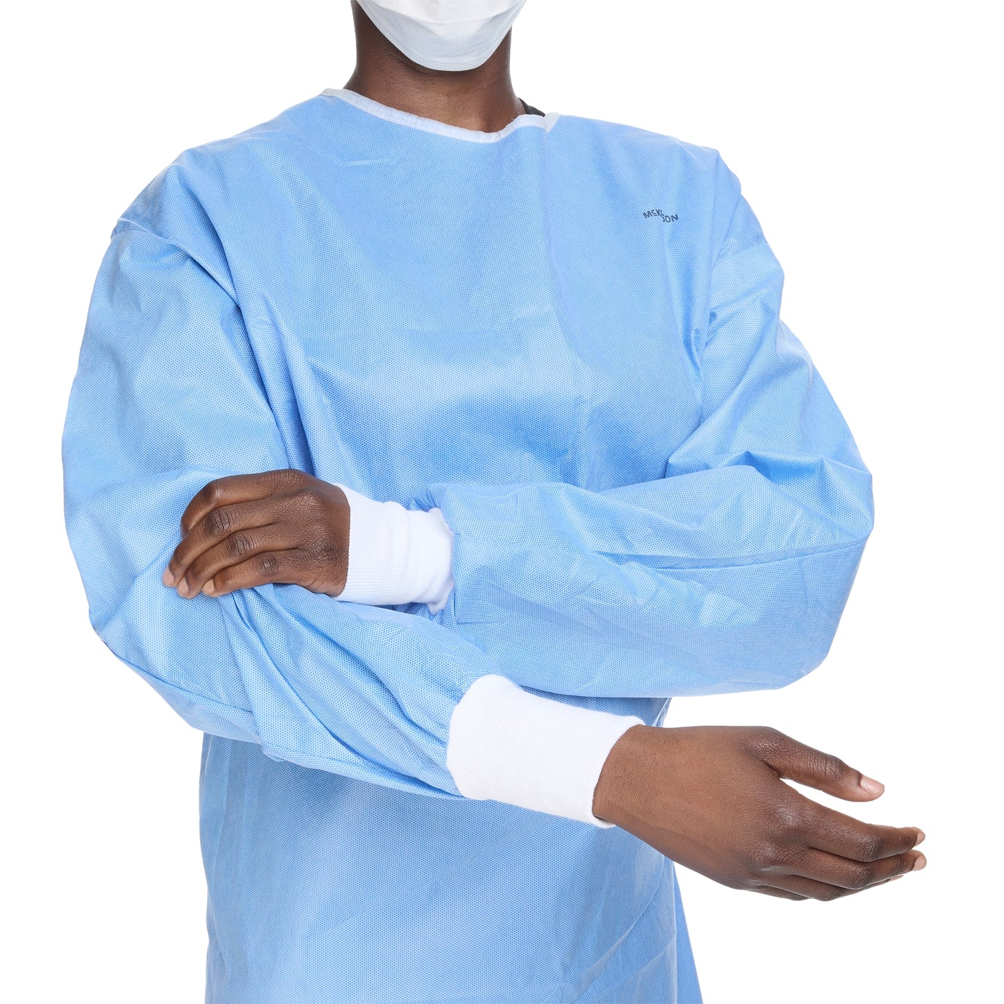 Person wearing a blue medical gown with white cuffs on a white background