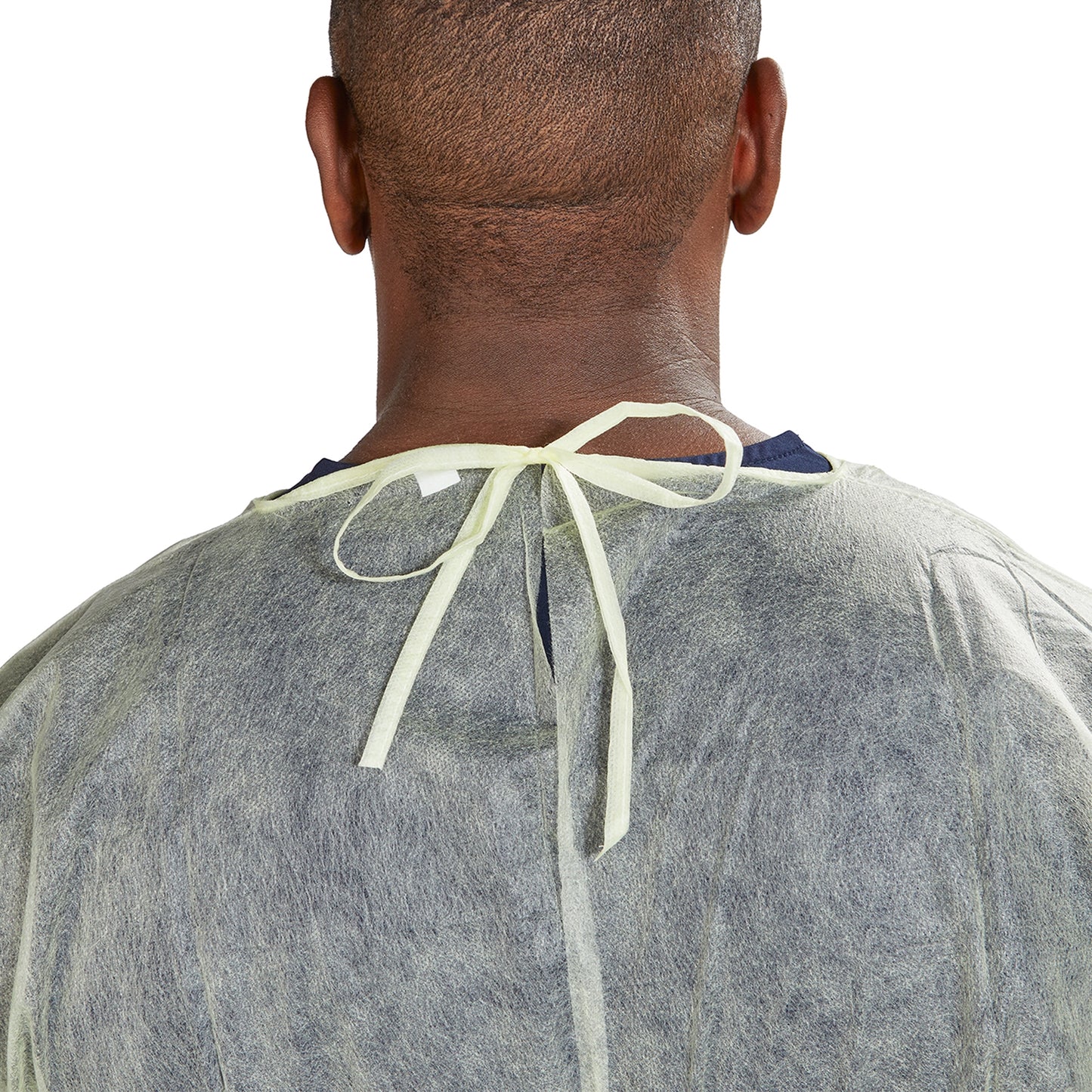 Person wearing a gray medical gown with a neck tie on a white background