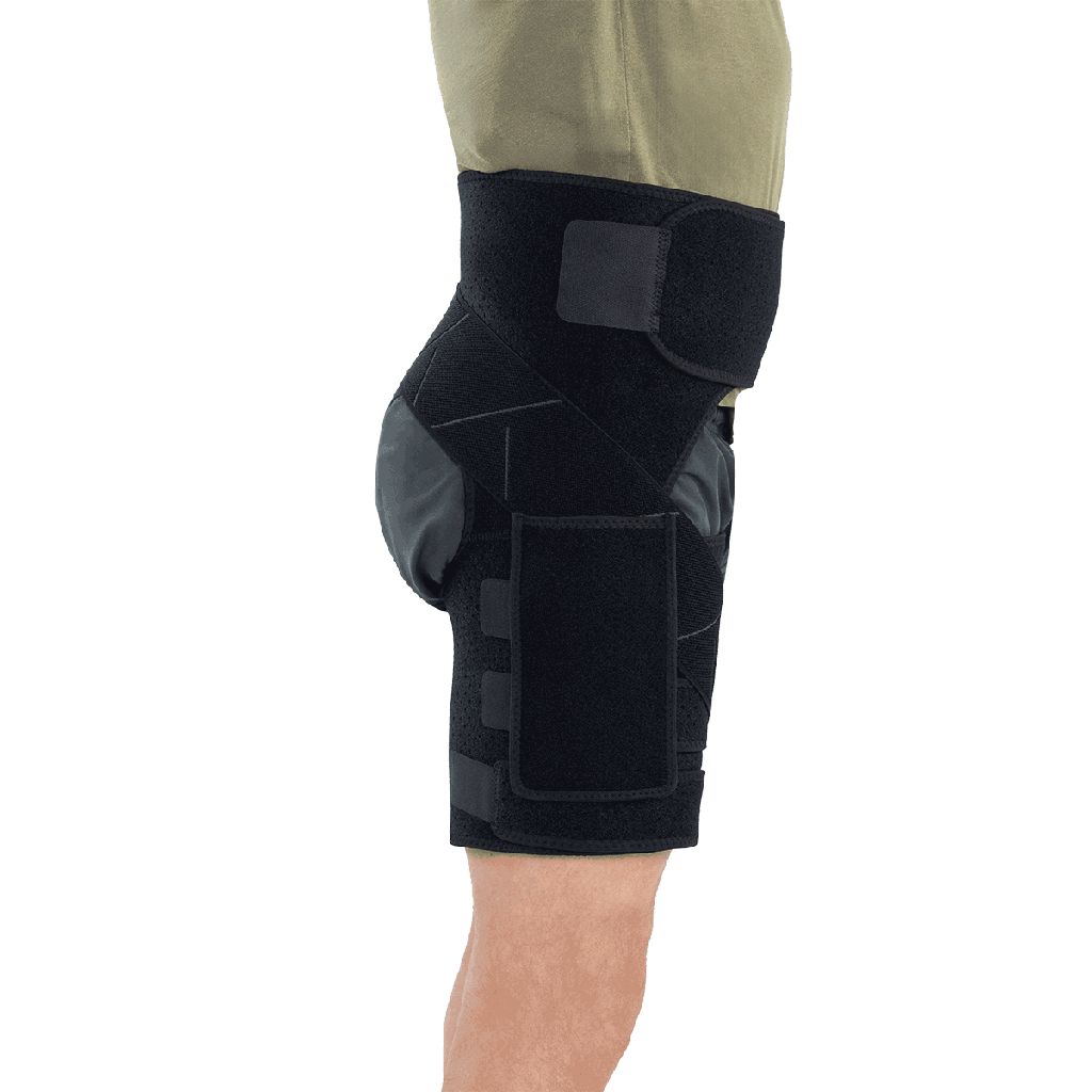 Black knee brace on a person's leg against a white background