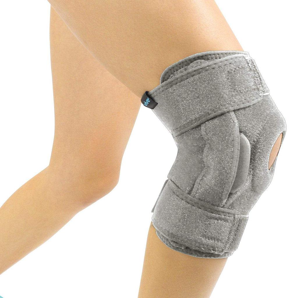 Gray knee brace on a person's knee with a white background