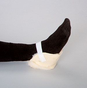 Person wearing black socks with a white bandage on a gray background