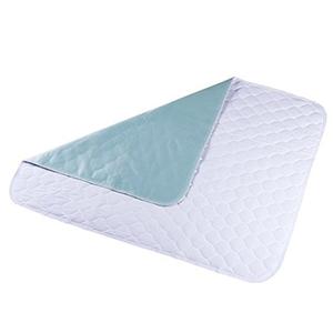 Light blue and white quilted blanket on a white background
