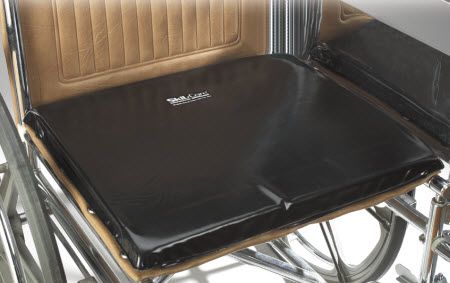 Black wheelchair cushion on a wheelchair with visible brand name.